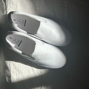 NoBo white slip ons.